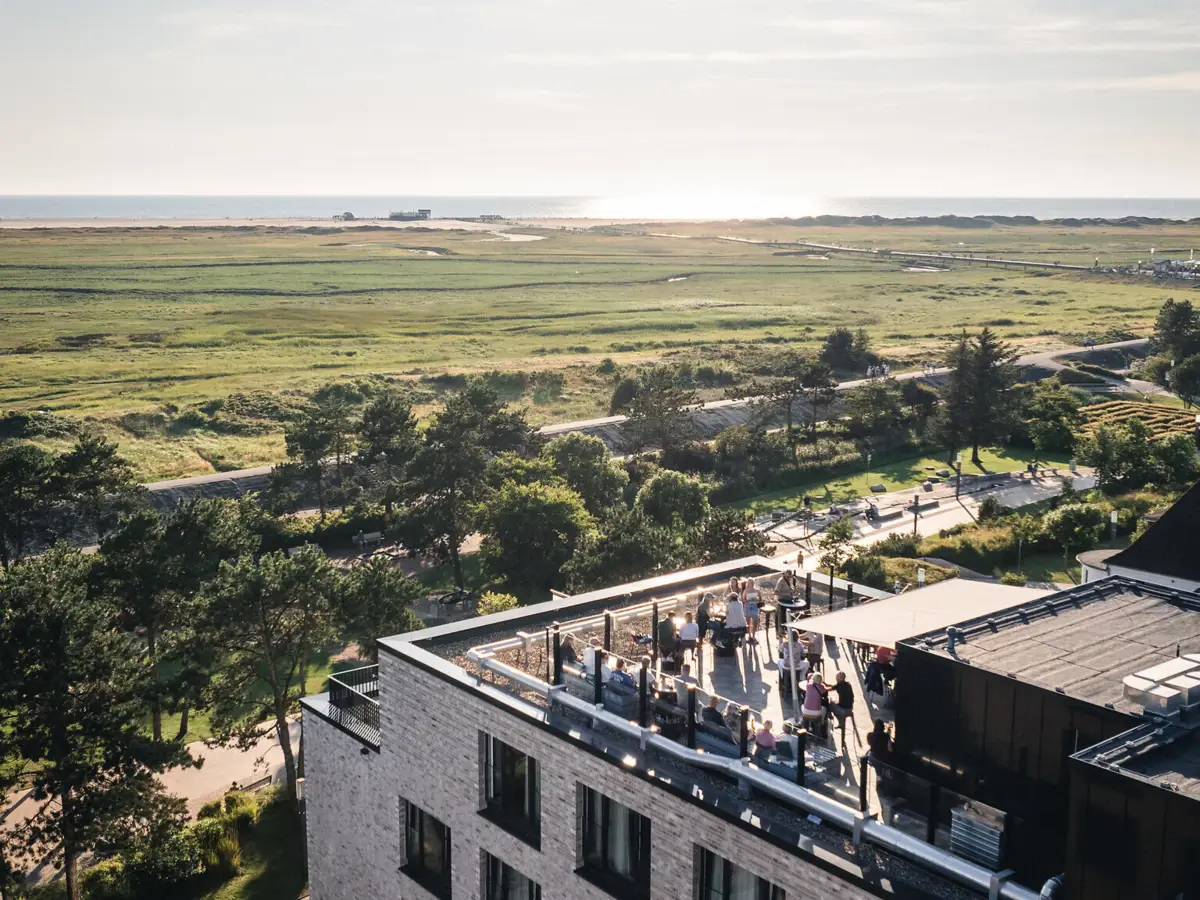 Urban Nature St. Peter-Ording Das Urban Nature Hotel St. Peter-Ording mit einer Dachterrasse und Blick über die Salzwiesen hin bis zum Strand.