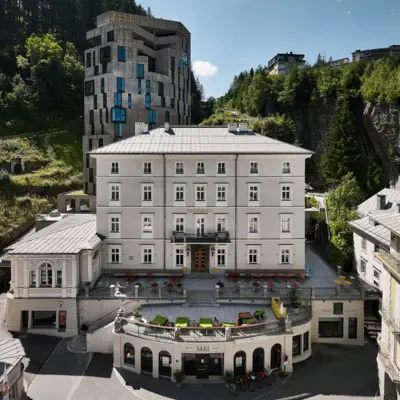 Alpine house in Bad Gastein at sunrise, set against rugged mountain scenery